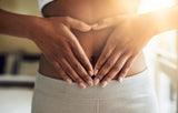 woman holding her hands over her stomach