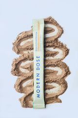 Modern Dose Stress & Mood Balance Honey stick pack laying over its powder - www.moderndose.com