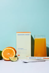 Modern Dose Joint Support box, stick pack, and drink with limes and oranges and a spoon - www.moderndose.com
