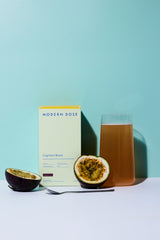 Modern Dose Cognition Boost box and drink next to sliced passion fruit and a spoon - www.moderndose.com