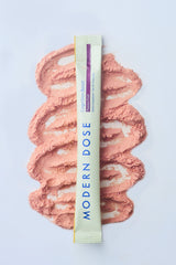 Modern Dose Cognition Boost stick pack in passion fruit laying on its powder - www.moderndose.com