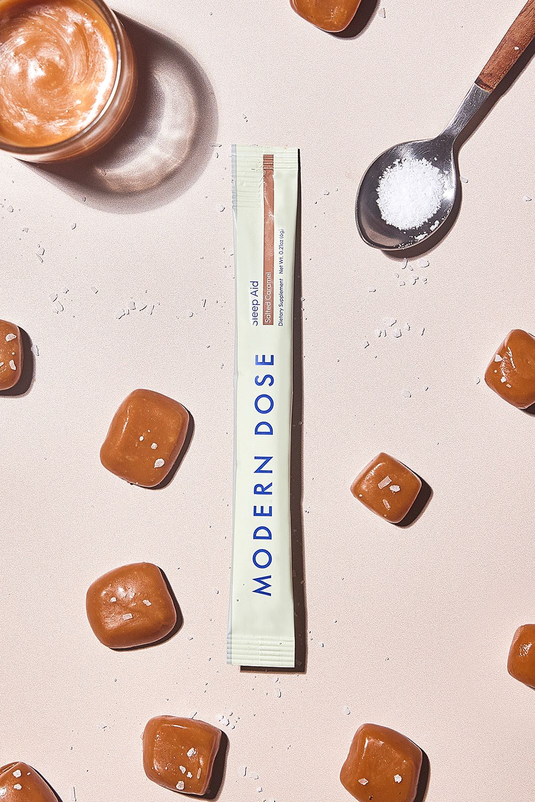 Modern Dose Sleep Aid Salted Caramel stick pack surrounded by caramel and a spoon full of salt - www.moderndose.com