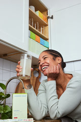 happy female customer in her kitchen with Modern Dose Biotic Blend strawberry - www.moderndose.com